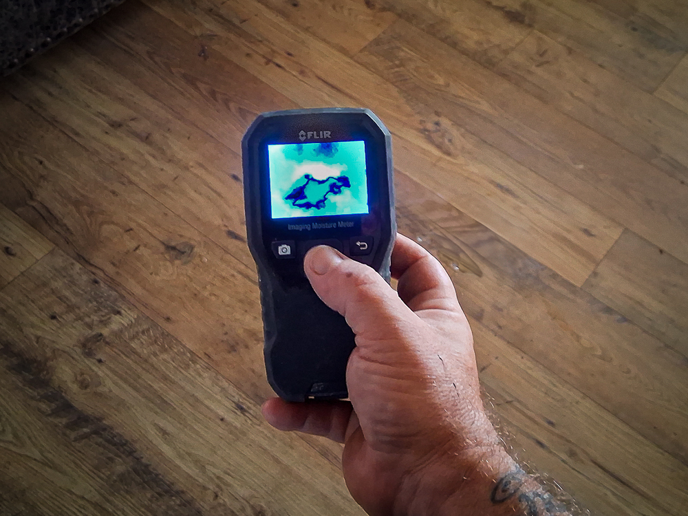 A plumber in Escondido uses a thermal imaging camera to locate a slab leak. 