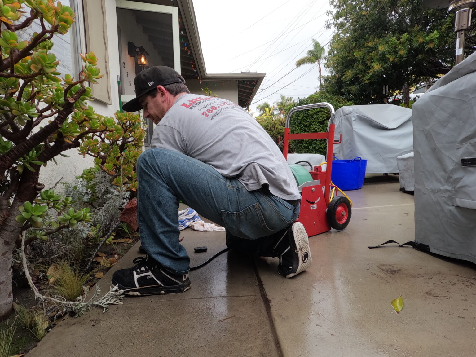 DCIM100GOPROGOPR0386.JPG Chris, owner of Little Guy Plumbing, cleans a drain using an outdoor clean-out as an access point.