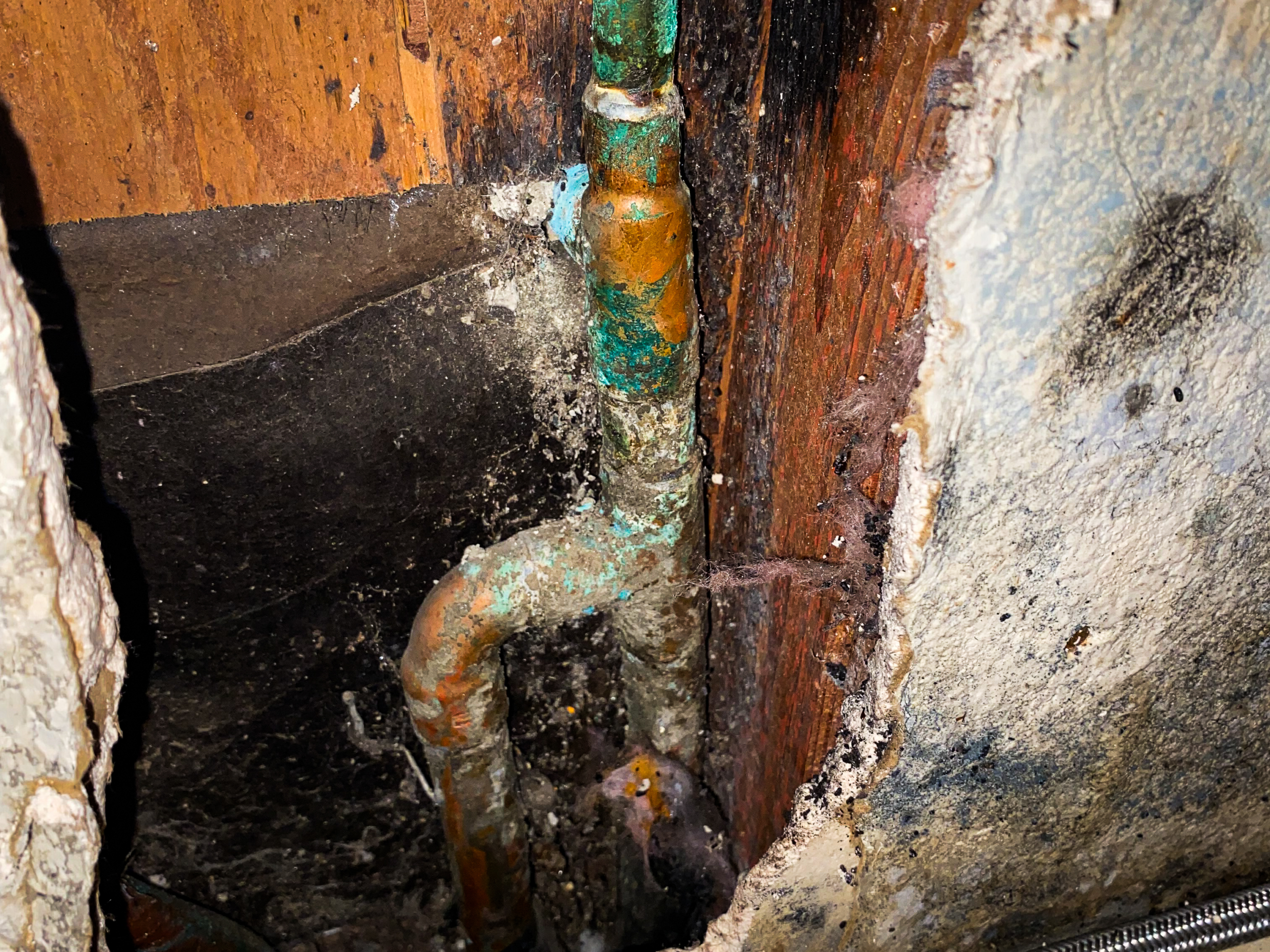 corroded-copper-in-slab A water reroute is needed after a plumber exposes corroding copper pipes beneath the slab.