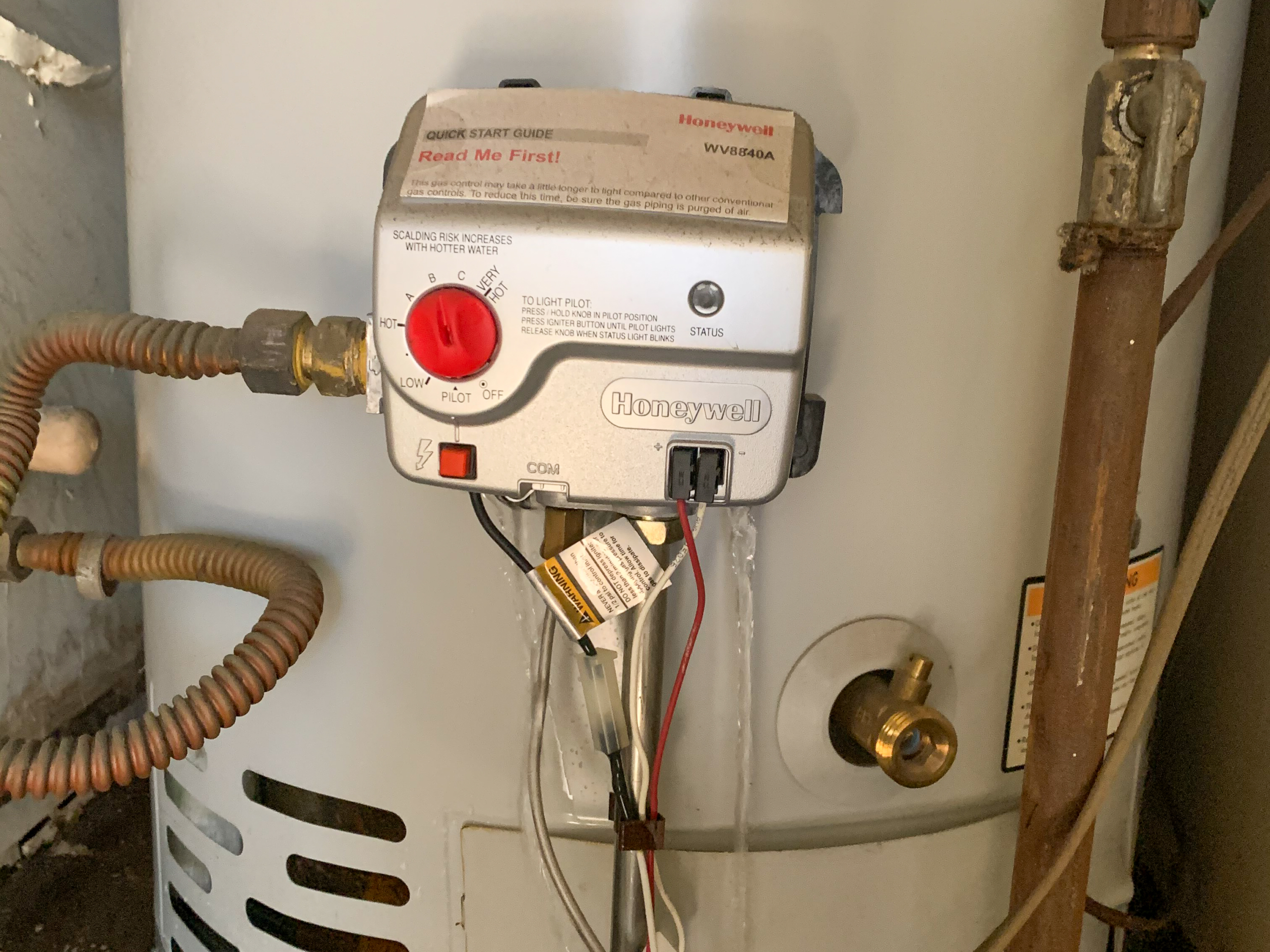A failing water heater is inspected to determine if it can be repaired or needs replacement.