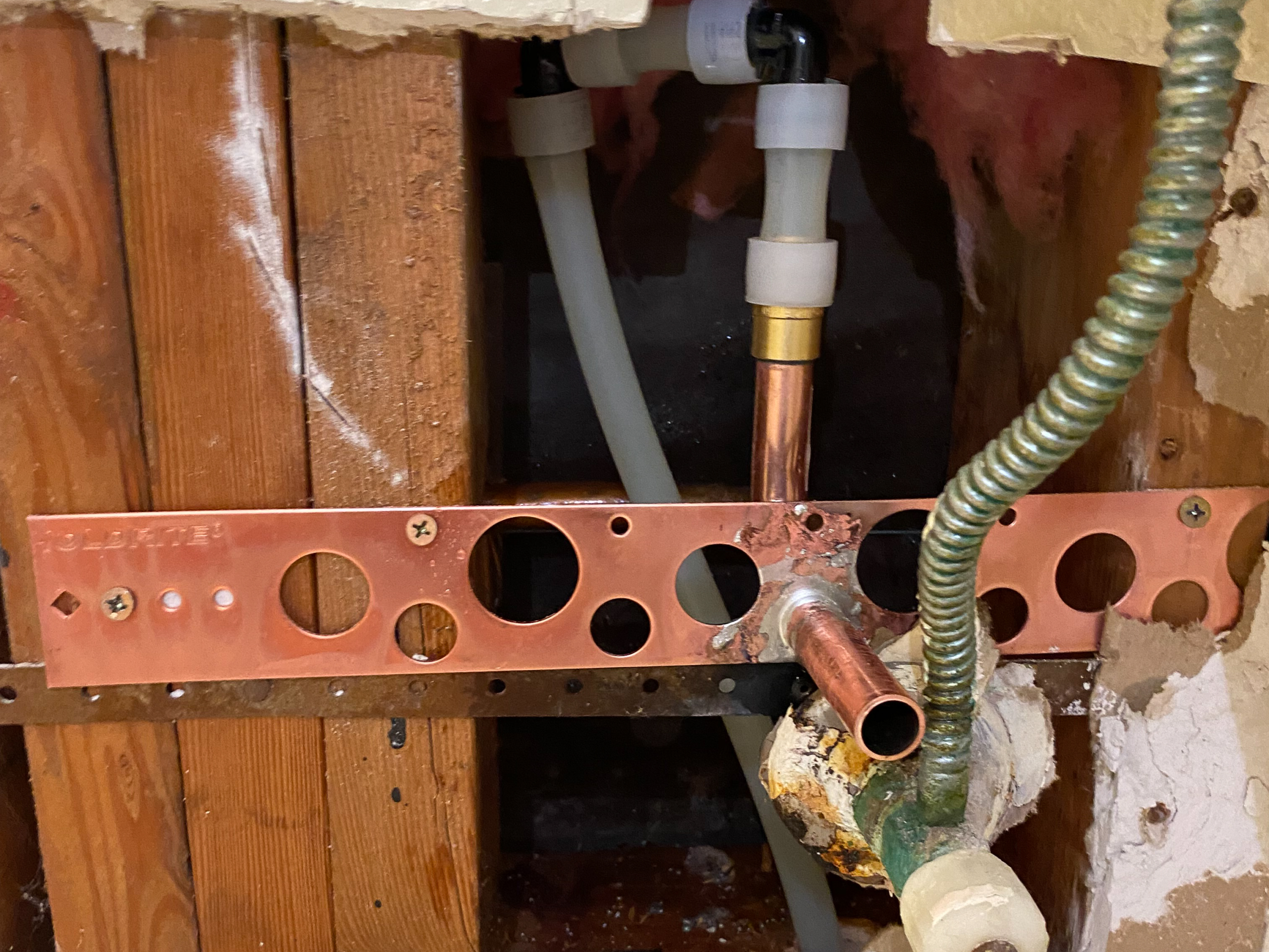 A water line feeding a bathroom toilet has been rerouted using a combination of PEX and copper.