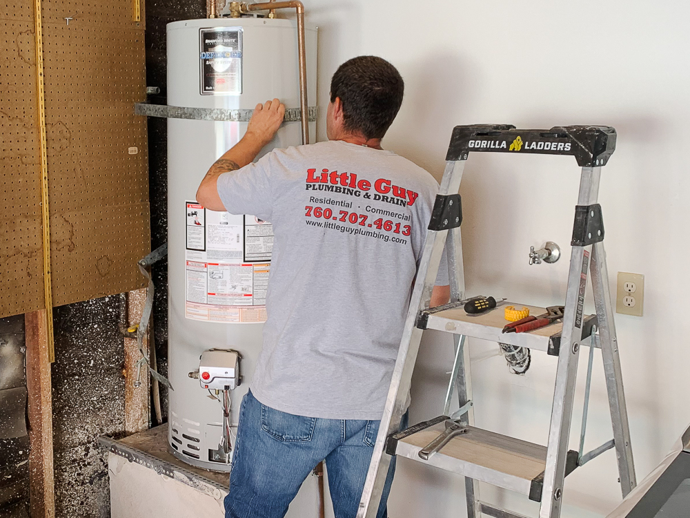 A water heater repair technician troubleshoots a failing unit in Escondido.