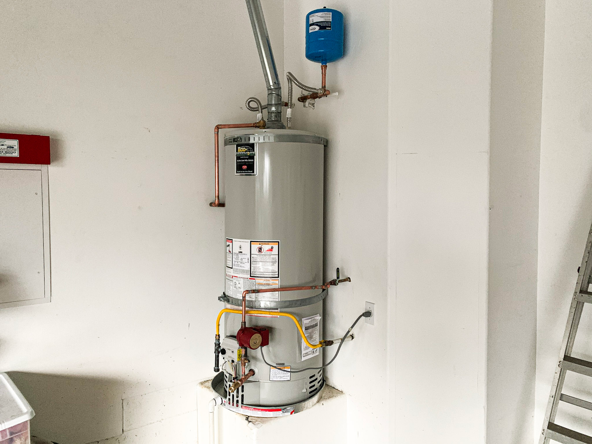 A complete water heater installation includes an expansion tank, recirulating pump and gas sediment trap.
