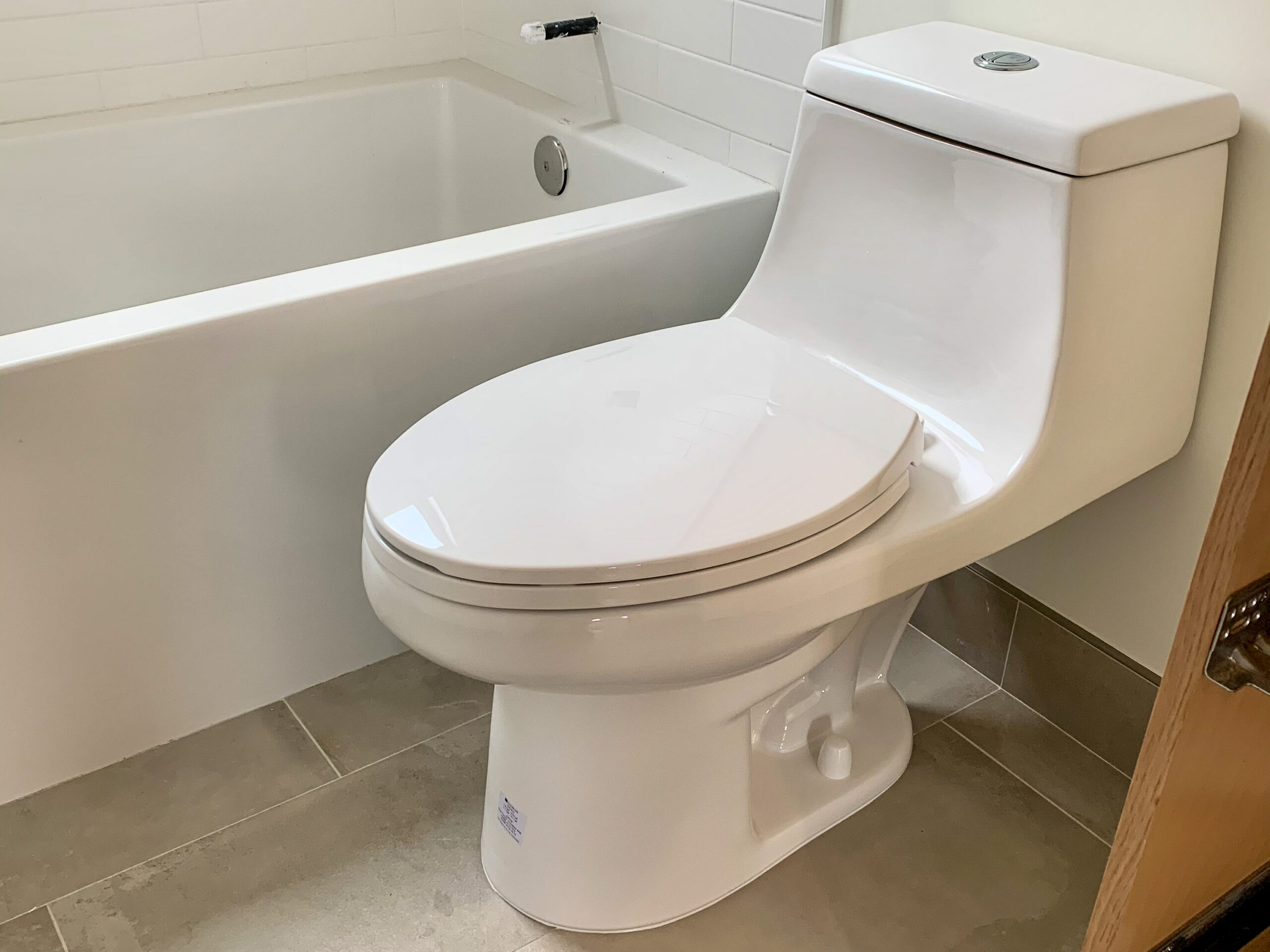 bathroom-fixture-installation Professional installation of high-quality bathroom fixtures, including a new one-piece toilet.