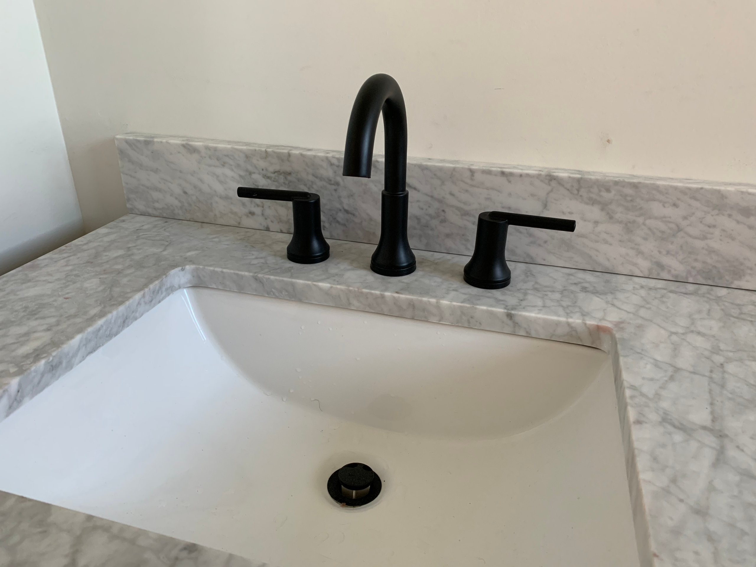 faucet-fixture-replacement A wide-spread lav faucet with satin black finish is professionally installed in an Escondido home during a bathroom remodel.