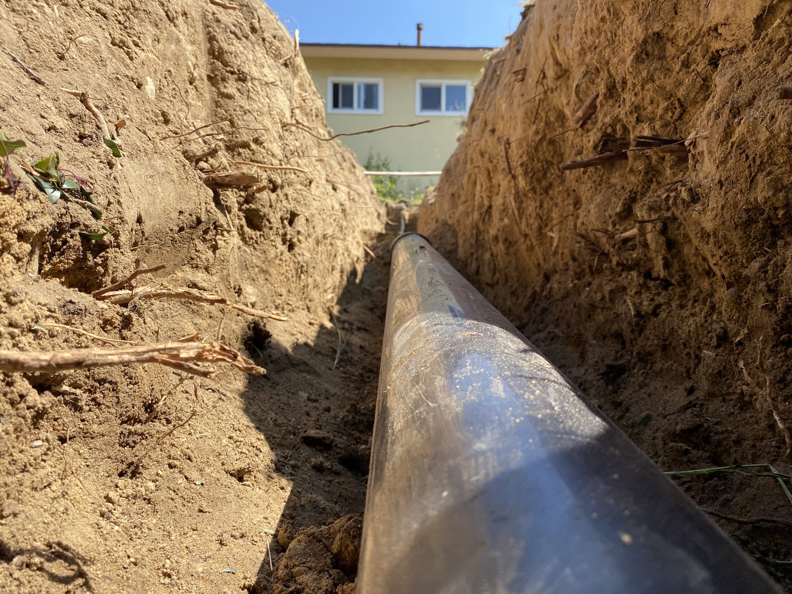 A main sewer line made of ABS plastic is exposed for inspection and repair at a property in Escondido.