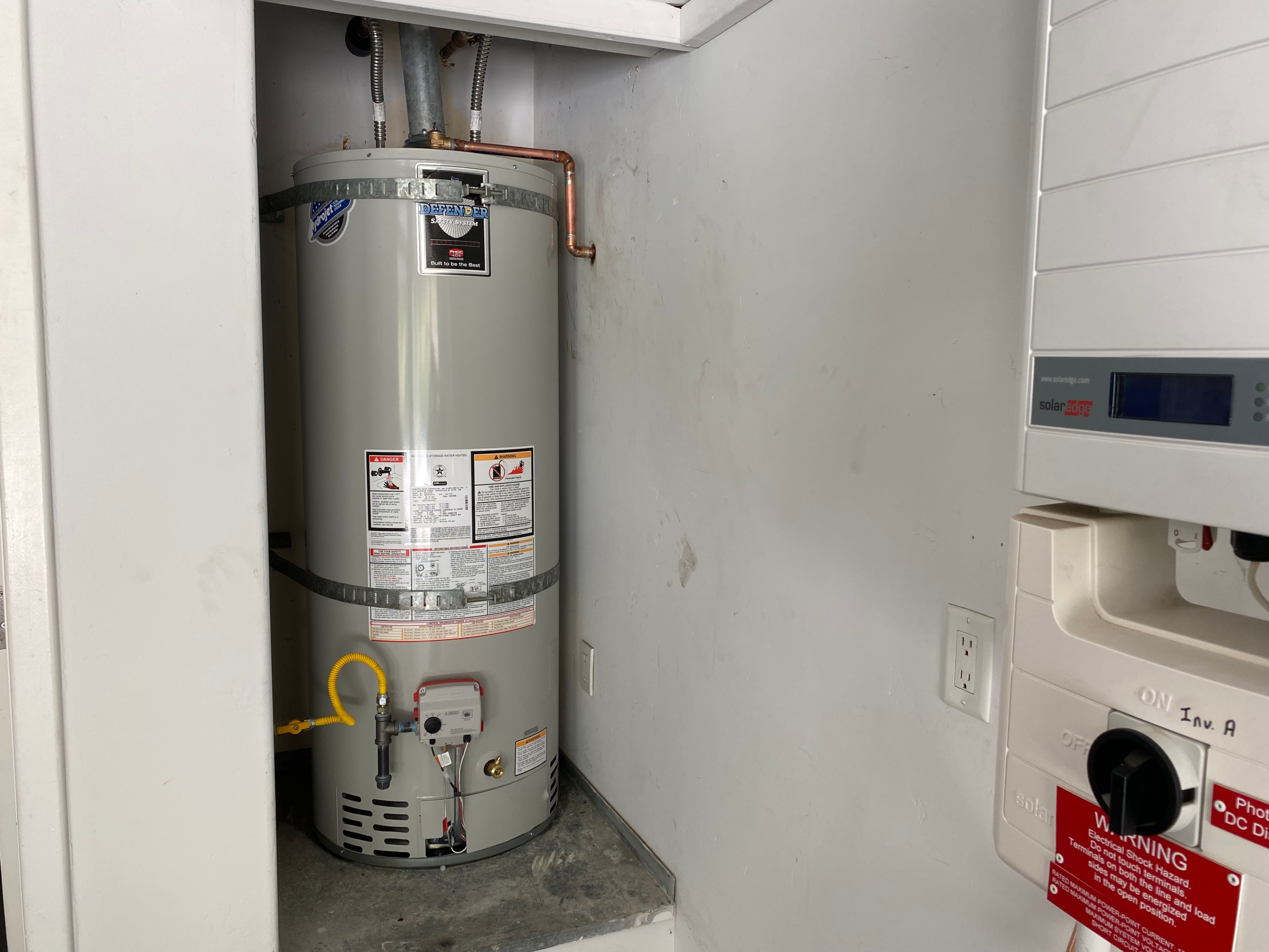 A proffesionally installed water heater with gas sediment trap, up-to-code gas flex supply line and firmly anchored earthqualke straps.