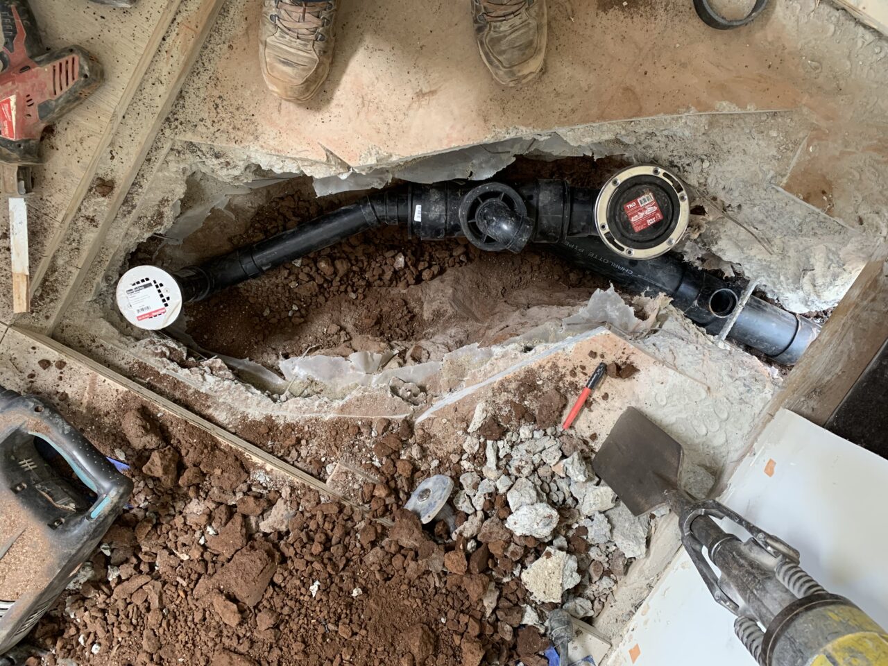 A garage is being remodeled into an ADU, which required the breaking of concrete and installation of new sewer and drain lines.
