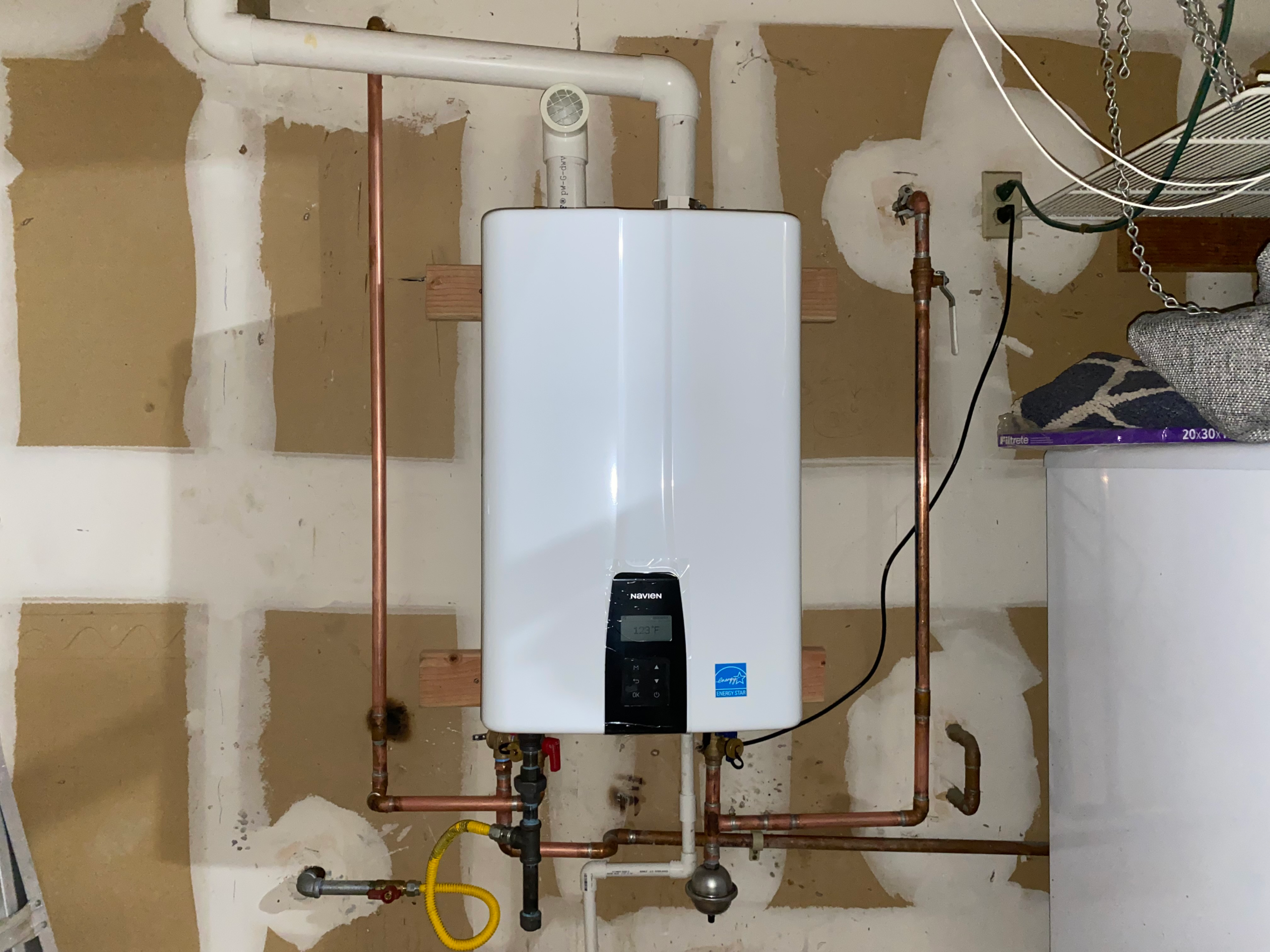 A new Navien tankless water heater is installed in the garage of an Escondido home to provide on-demand hot water efficiently.