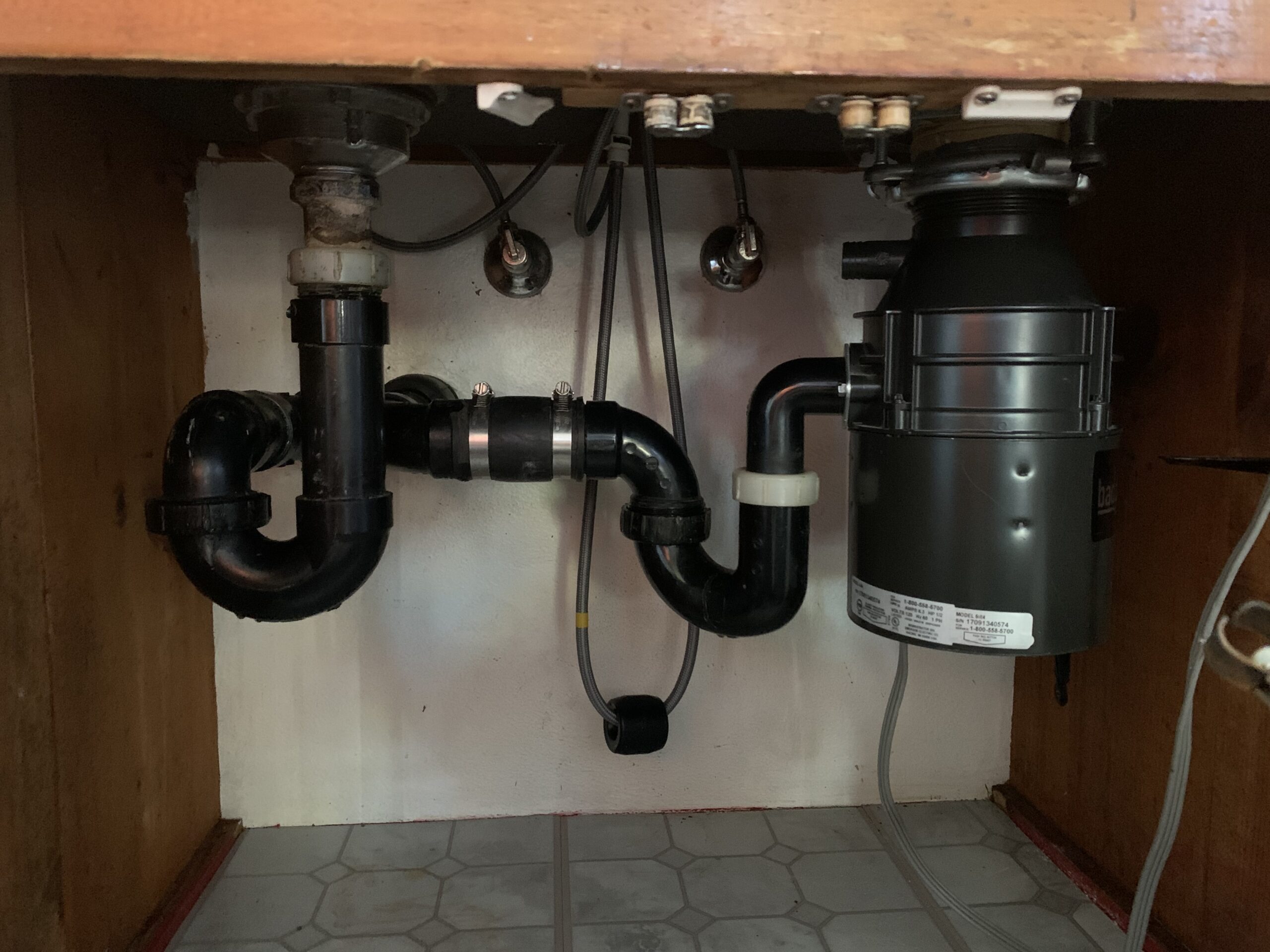 under-kitchen-sink-plumbing Faucet installation may reveal underlying issues with your kitchen plumbing.