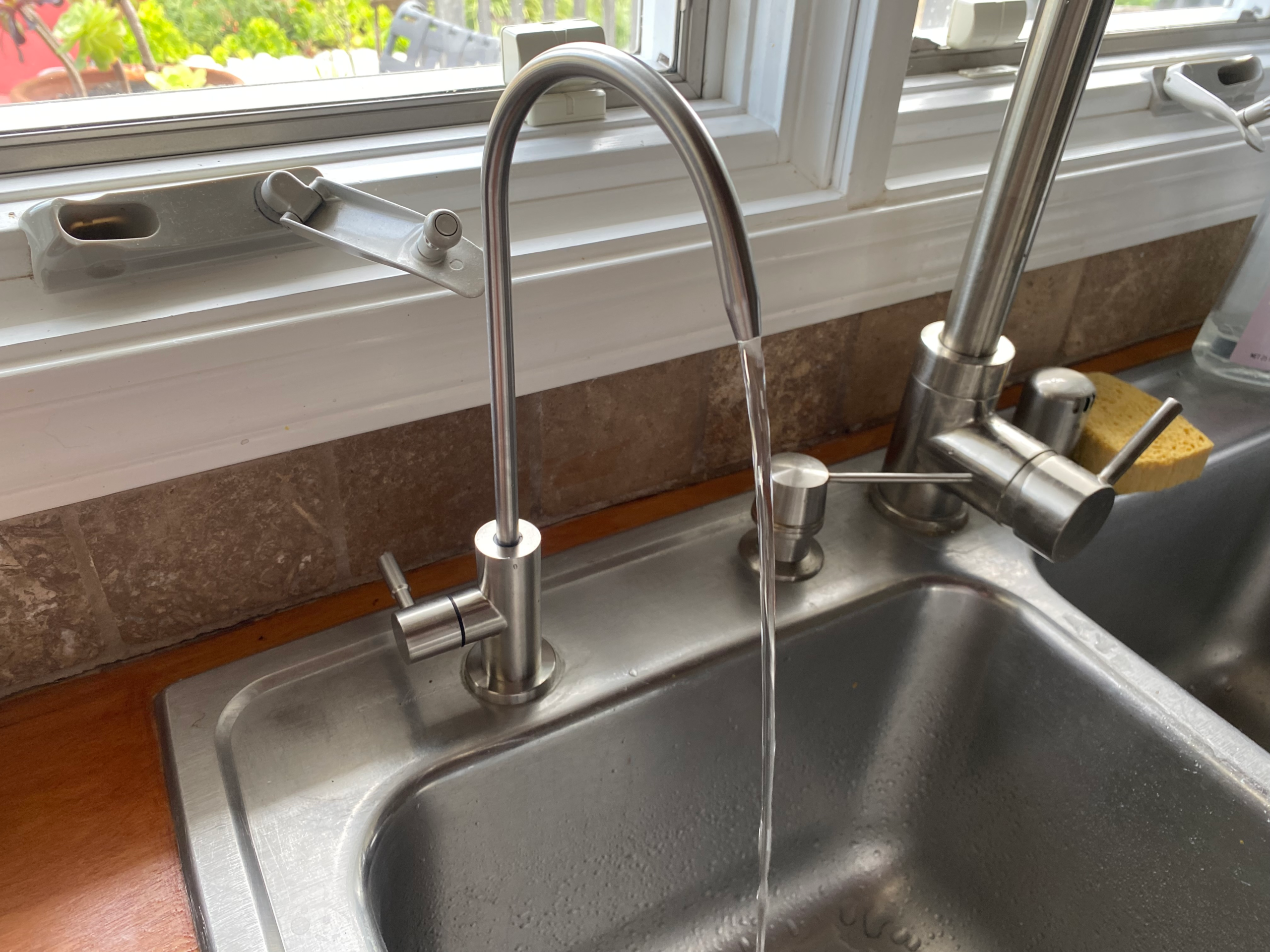 water-filtration-installation An under-sink reverse osmosis (RO) filter comes with a stainless steel drinking water faucet that mounts to the kitchen sink deck for convenience.