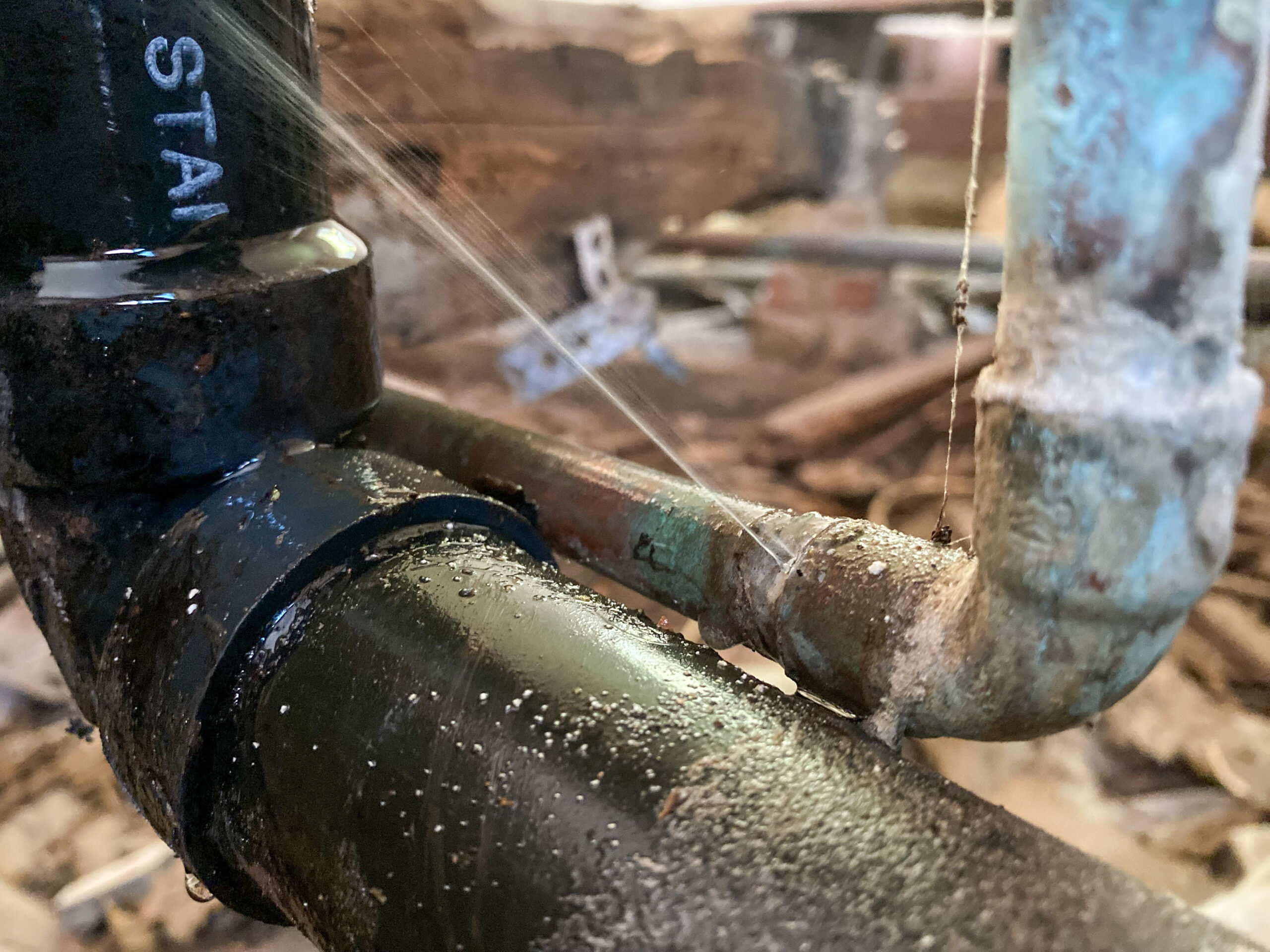 leak-detection-repair-services A plumber provides leak detection services in a residential home using a thermal imaging camera.