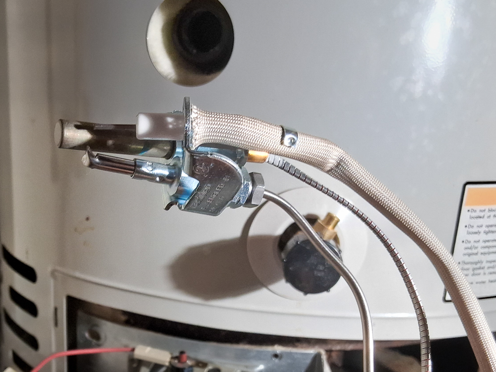 thermopile-replacement A new thermopile is installed on a Bradford White water heater during gas control valve replacement.